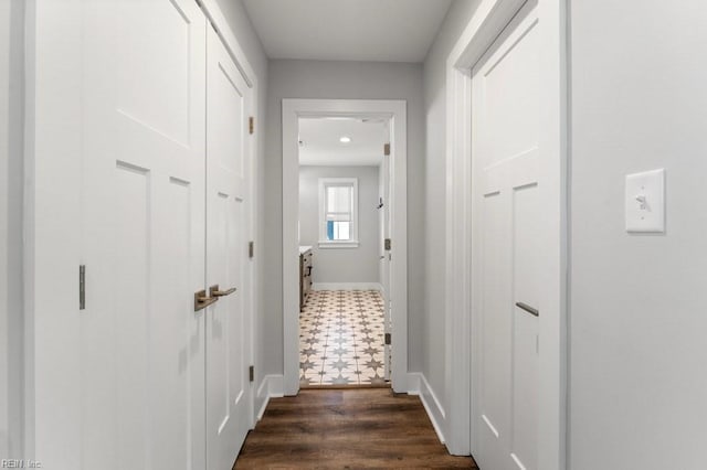 hall with dark wood-type flooring