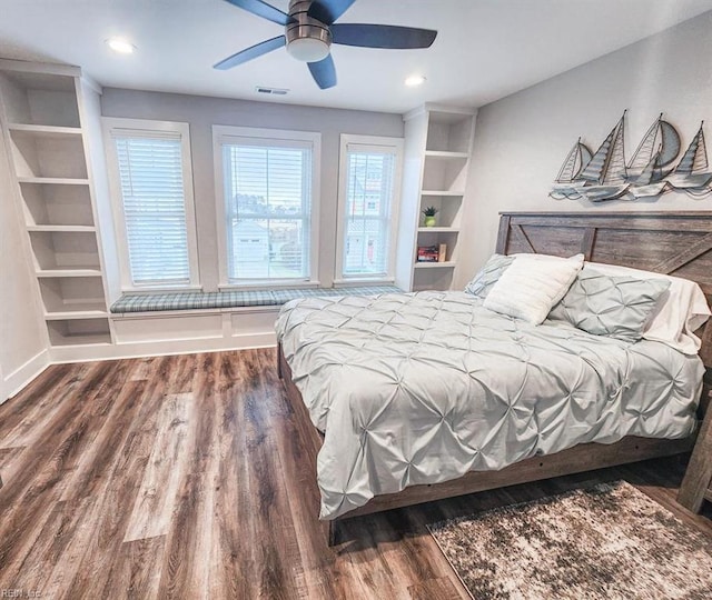 bedroom with dark hardwood / wood-style flooring and ceiling fan