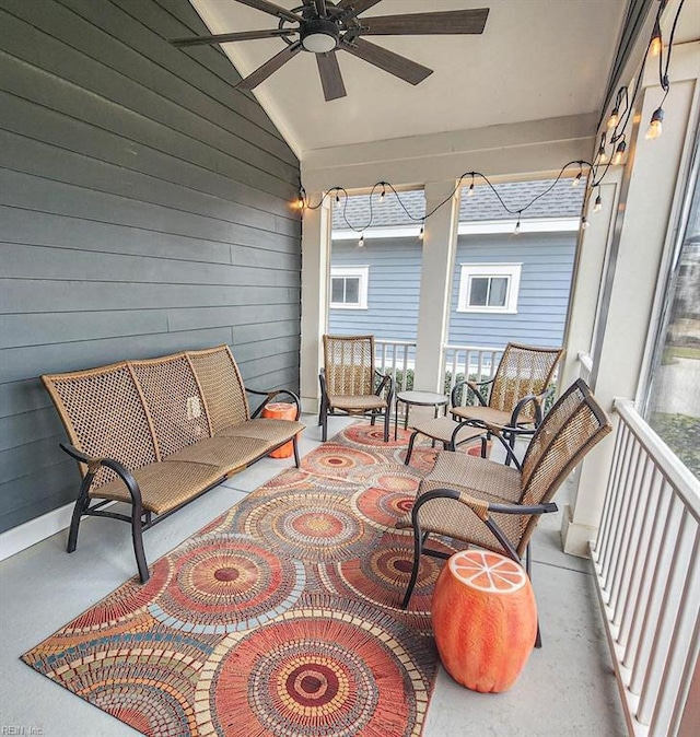 sunroom featuring lofted ceiling and ceiling fan