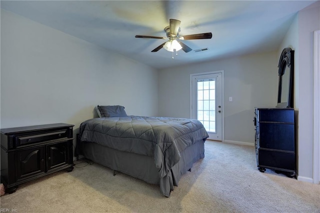 bedroom featuring access to exterior, light carpet, visible vents, and baseboards