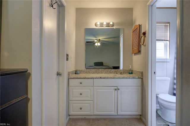 bathroom with ceiling fan, vanity, toilet, and ensuite bathroom