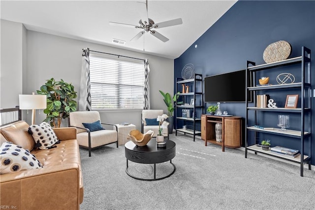 living room with carpet, visible vents, ceiling fan, and lofted ceiling