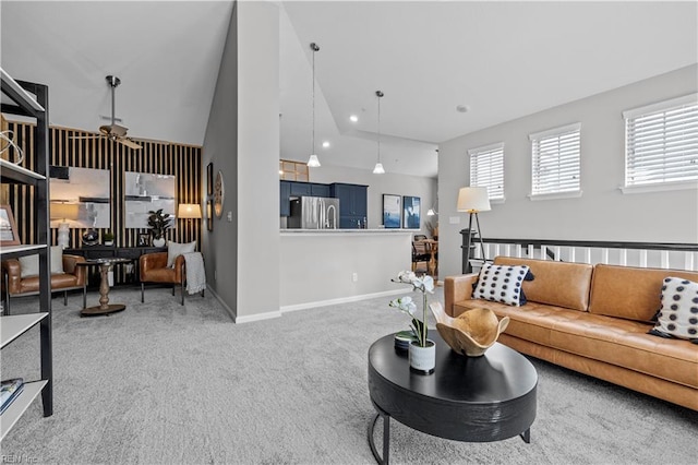 living area with plenty of natural light, carpet, baseboards, and vaulted ceiling