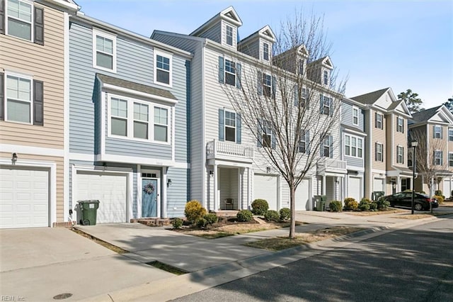 multi unit property featuring driveway, a garage, and a residential view