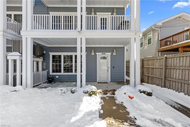 exterior space featuring a porch and fence