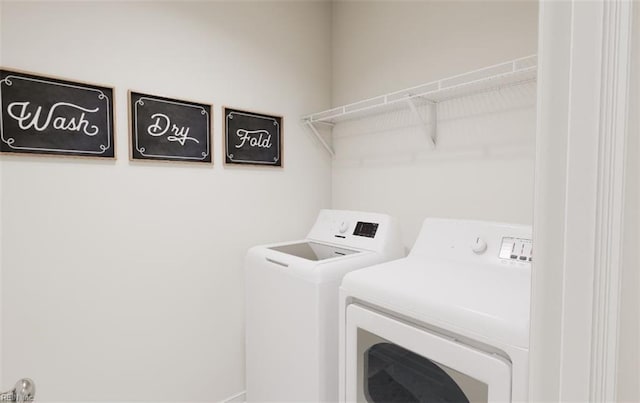 clothes washing area featuring washer and dryer