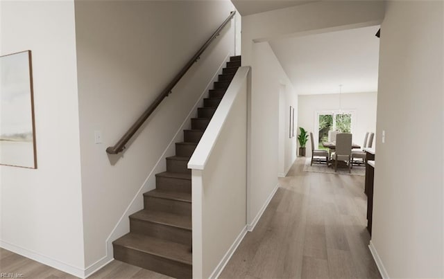 stairway featuring wood-type flooring