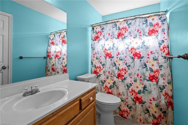 bathroom featuring toilet, tile patterned floors, a shower with shower curtain, and vanity