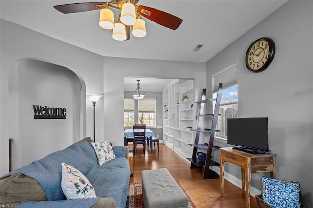 living room featuring ceiling fan and hardwood / wood-style floors