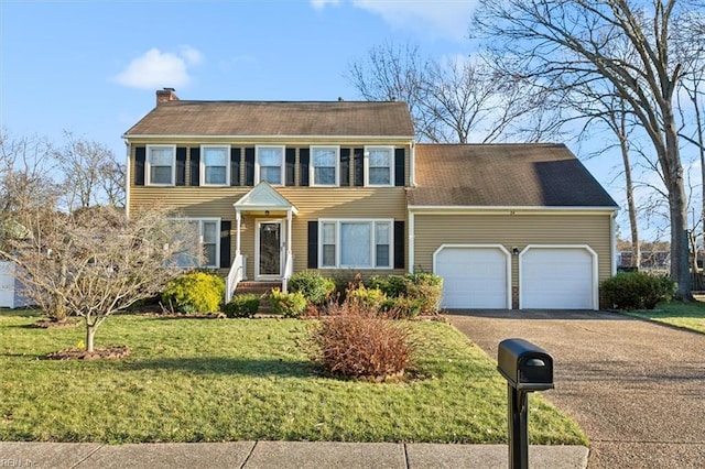 colonial house with a garage and a front yard