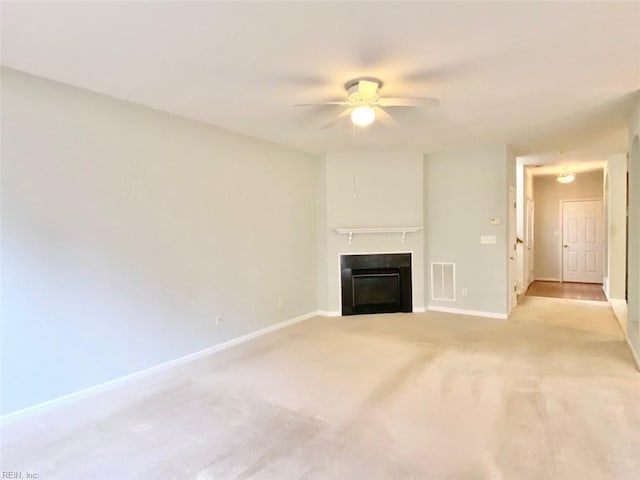 unfurnished living room featuring ceiling fan and light colored carpet