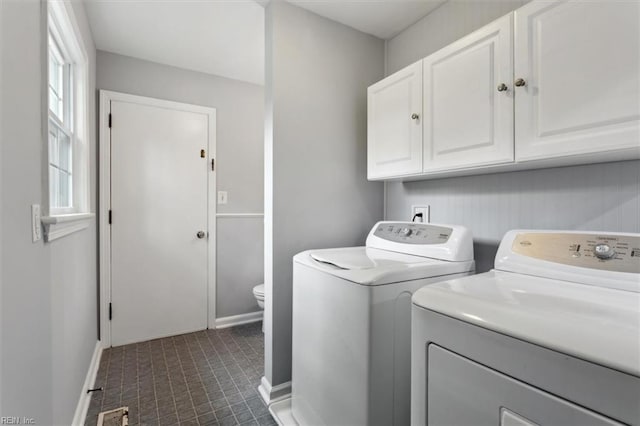 washroom with independent washer and dryer and cabinets