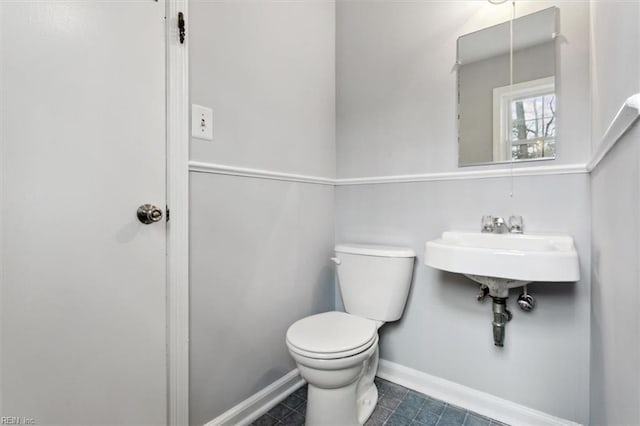 bathroom featuring toilet and tile patterned floors