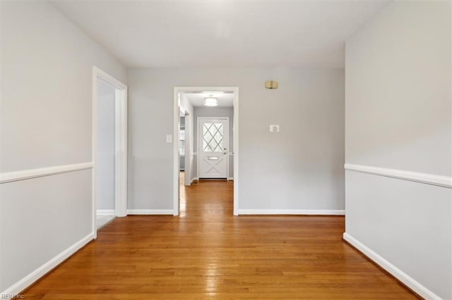 hall with hardwood / wood-style floors