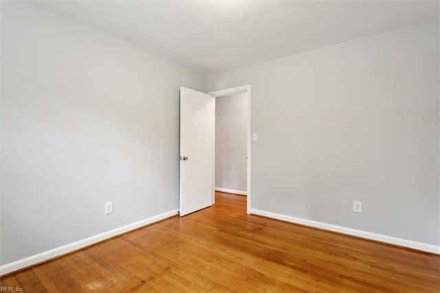 empty room with hardwood / wood-style flooring