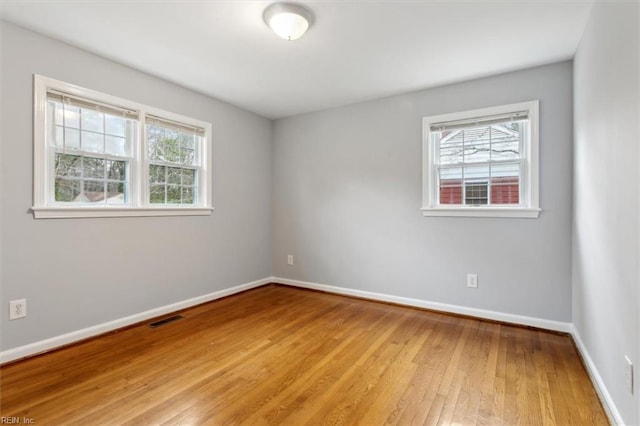 unfurnished room with light wood-type flooring and a healthy amount of sunlight