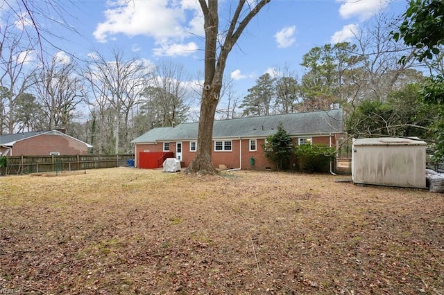 rear view of property featuring a shed