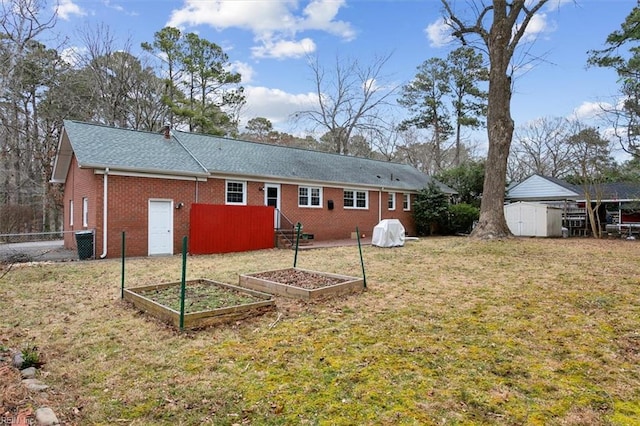 back of property featuring a lawn, a storage shed, and cooling unit