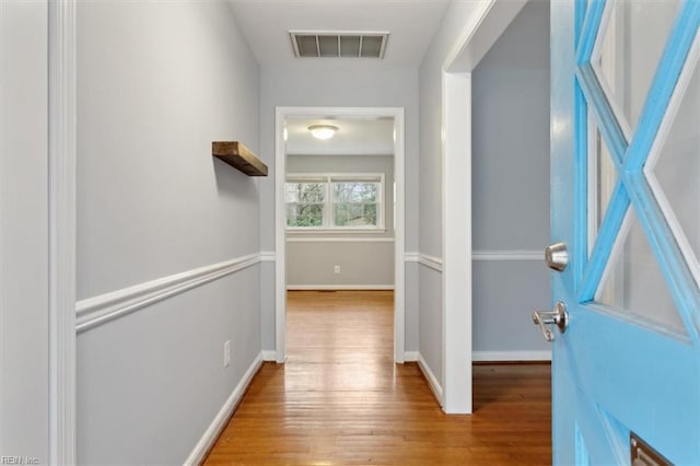 corridor with light hardwood / wood-style floors