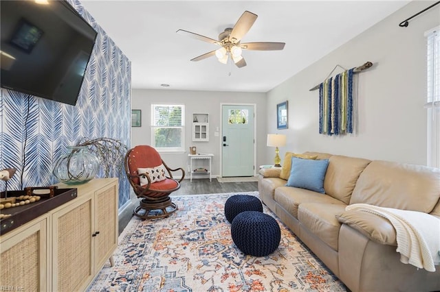 living room featuring ceiling fan and dark hardwood / wood-style floors