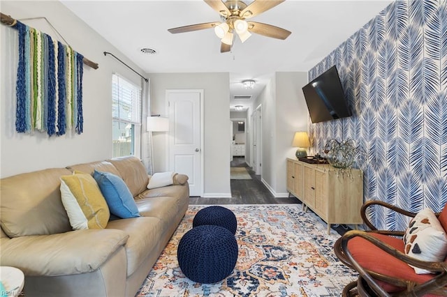 living room with ceiling fan and dark hardwood / wood-style flooring