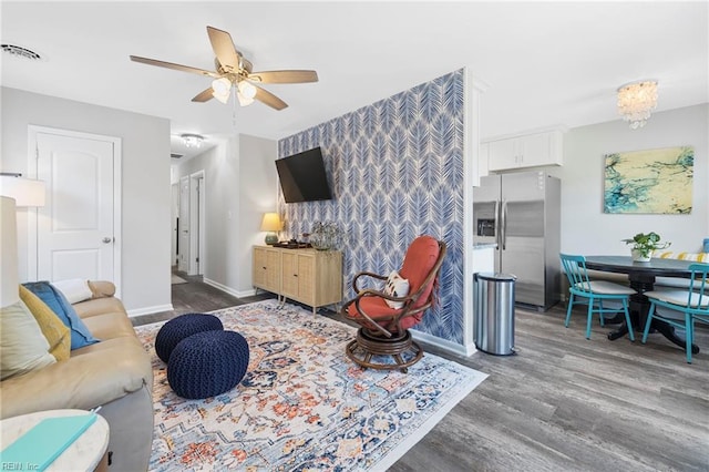 living room with ceiling fan and dark hardwood / wood-style flooring