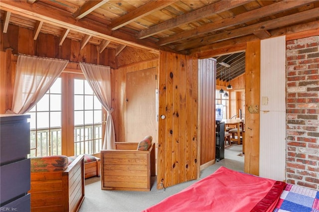 carpeted bedroom featuring wooden walls, beamed ceiling, and wood ceiling