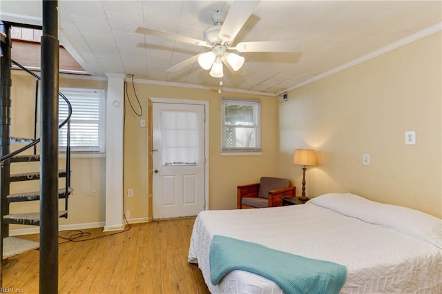 bedroom featuring ornamental molding, ceiling fan, and light hardwood / wood-style flooring