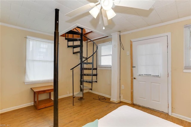 foyer entrance featuring crown molding and wood-type flooring