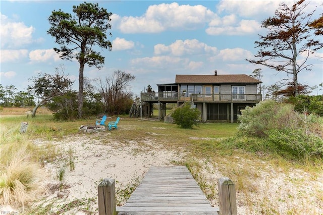 exterior space with a wooden deck and an outdoor fire pit