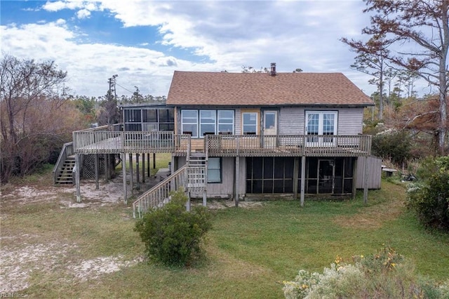 back of house with a sunroom, a lawn, and a wooden deck