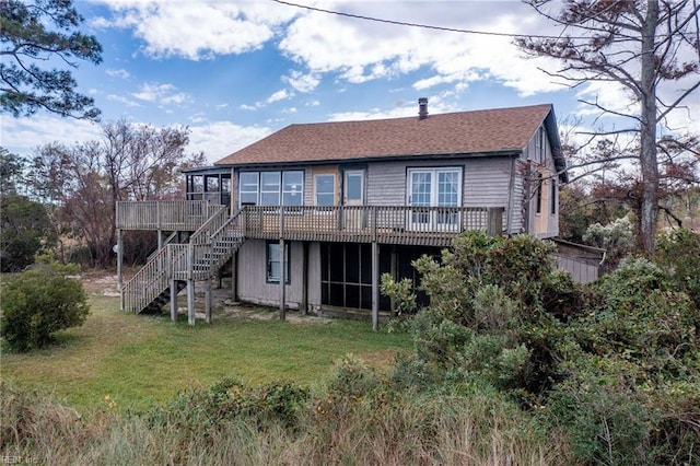 back of property featuring a lawn and a wooden deck