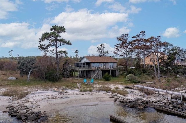 exterior space featuring a deck with water view