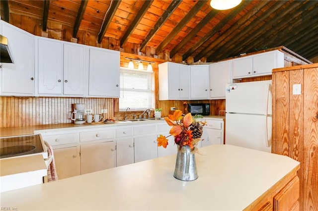 kitchen with white appliances, white cabinetry, and sink