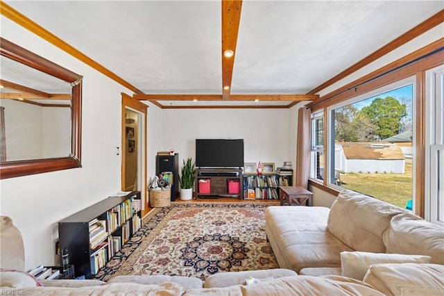 living room featuring crown molding and beam ceiling