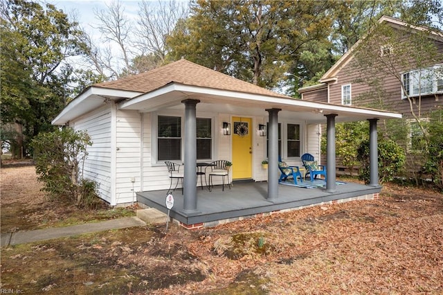 view of front of property with covered porch and roof with shingles