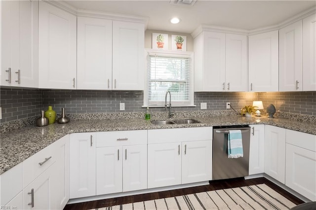 kitchen with a sink, white cabinetry, light stone counters, and dishwasher