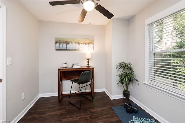 office area featuring dark wood finished floors, baseboards, and ceiling fan