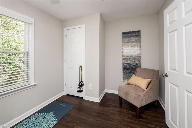 living area with dark wood-style floors and baseboards