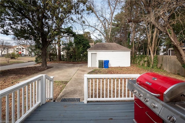 wooden deck featuring fence, area for grilling, and an outdoor structure