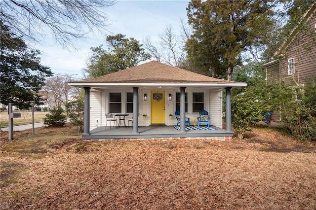 bungalow featuring a shingled roof and a porch