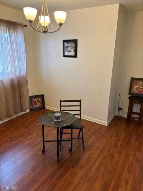 dining area with a chandelier and dark hardwood / wood-style flooring