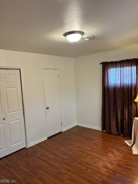 empty room featuring dark hardwood / wood-style flooring