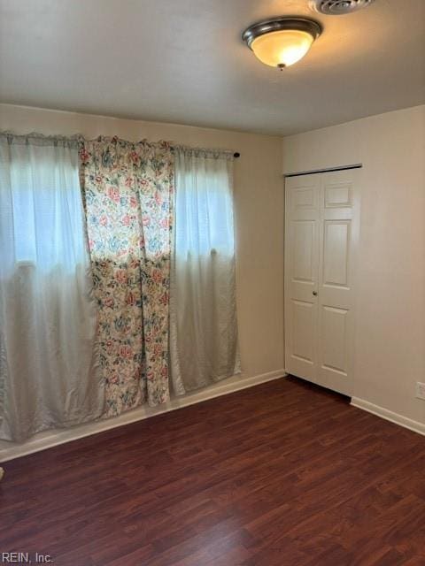 empty room featuring dark wood-type flooring