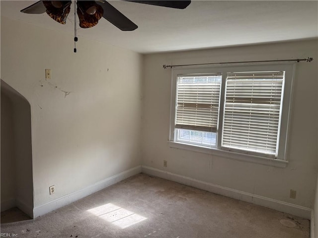 spare room featuring ceiling fan and light colored carpet