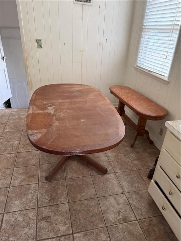 dining room with dark tile patterned floors