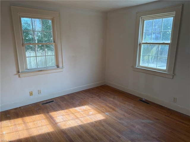 spare room featuring wood-type flooring