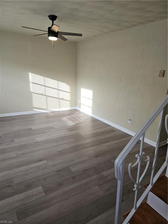 empty room featuring ceiling fan and dark hardwood / wood-style flooring