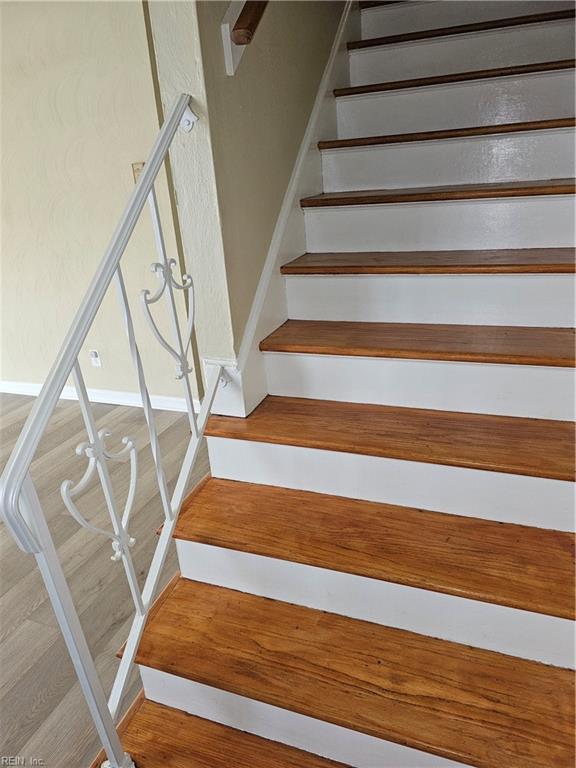 stairway featuring wood-type flooring