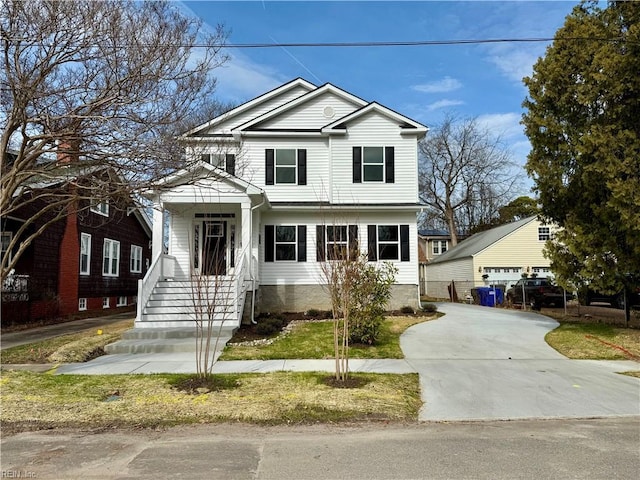 view of front facade with a garage and an outbuilding